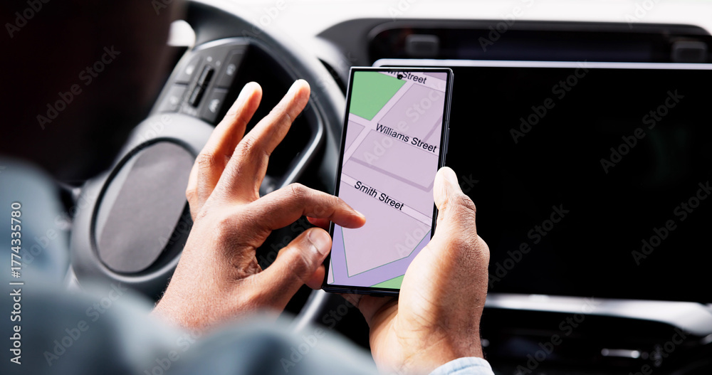 Naklejka premium The African American Man Uses His Smartphone