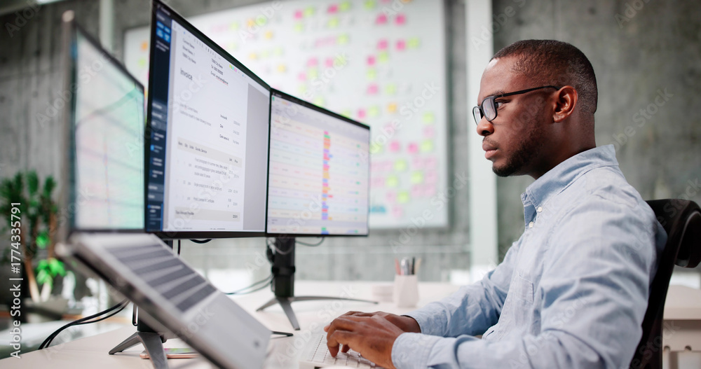 Naklejka premium Young African American Man Using Laptop