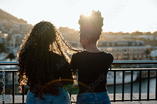 Friends silhouette watching the sunset