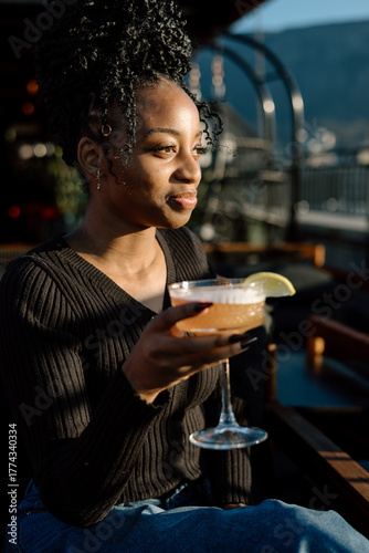 Women drinking a cocktail in an outdoor bar