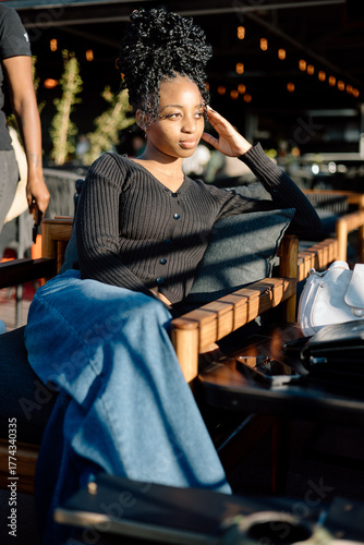 Young black female in an outdoor bar socialising