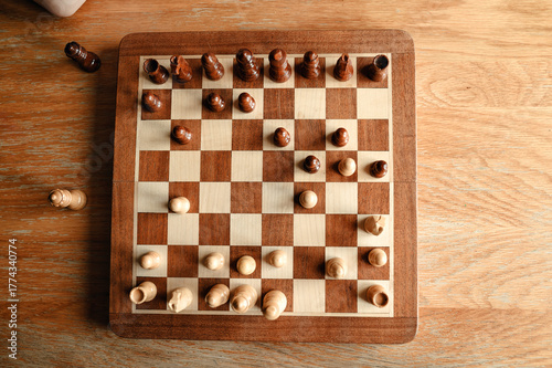 Top view of chessboard with pieces arranged in mid-game position.