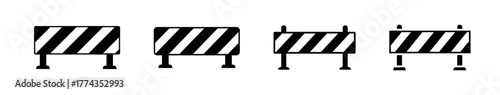 Four black and white striped construction barriers in a row.
