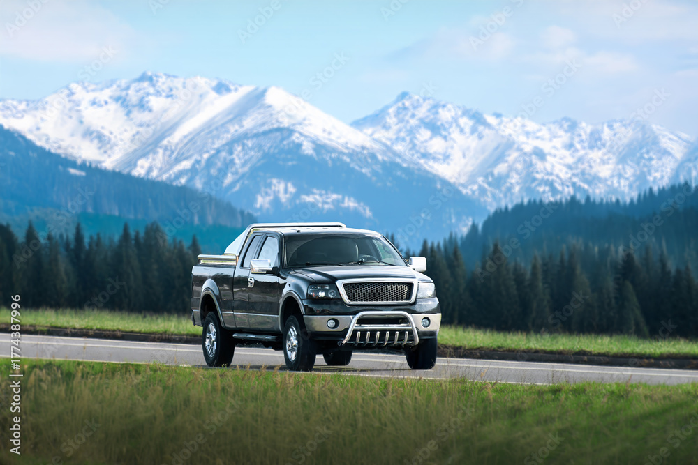 Fototapeta premium Black pickup truck driving on open highway