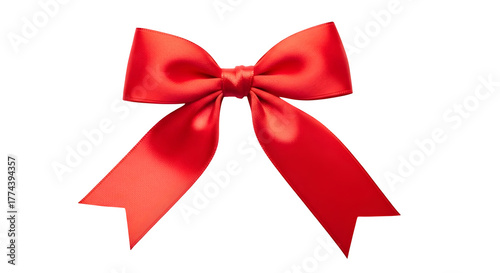 Red bow tie with satin texture on black, serves as holiday decor, greeting card element, or gift wrapping accent.