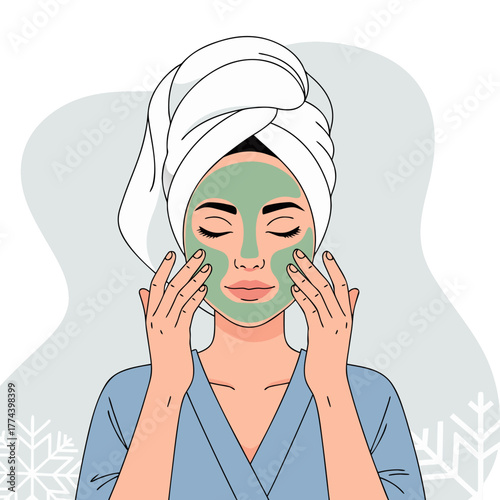 Woman applying green face mask while relaxing at home with towel  