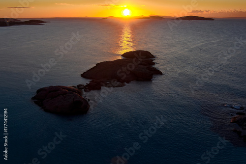 The sun paints the water golden as it rises over Twilight Beach, Esperance, to wake the day