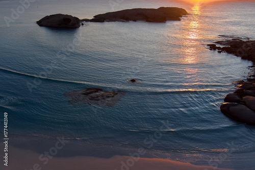The reflection of the morning sun adds contrast to the dark blue ocean near Esperance, Western Australia