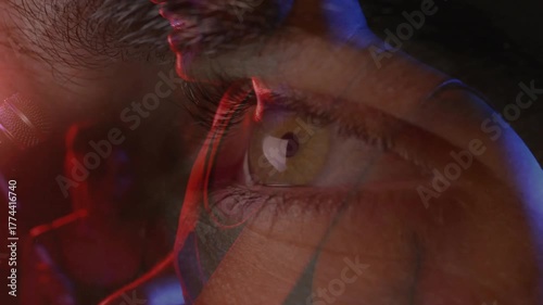 Shifting red blue lights over eye initiating music artist moving toward mic singing with co-singer