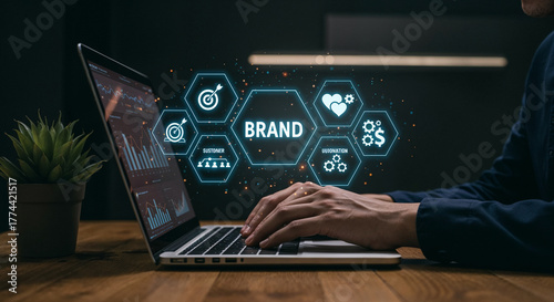 Person typing on laptop with brand strategy icons floating above branding marketing