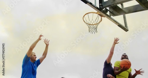 Basketball player catching pass and driving for layup on rooftop as defenders leaping net swishing