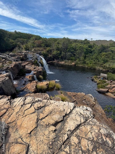 Beautiful waterfall surrounded by rocky cliffs and lush vegetation in Santana do Riacho, Minas Gerais, Brazil. Scenic natural landscape ideal for travel, adventure, and eco-tourism.