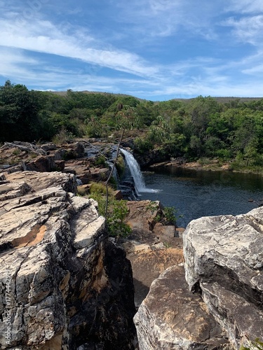 Beautiful waterfall surrounded by rocky cliffs and lush vegetation in Santana do Riacho, Minas Gerais, Brazil. Scenic natural landscape ideal for travel, adventure, and eco-tourism.