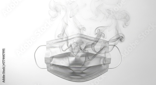 A surgical mask is surrounded by smoke, symbolizing the dangers of air pollution isolated on white background
