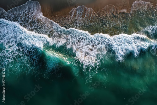 Aerial View Of Ocean Waves Breaking Along Coastline in Turquoise Blue and Golden Sunlight
