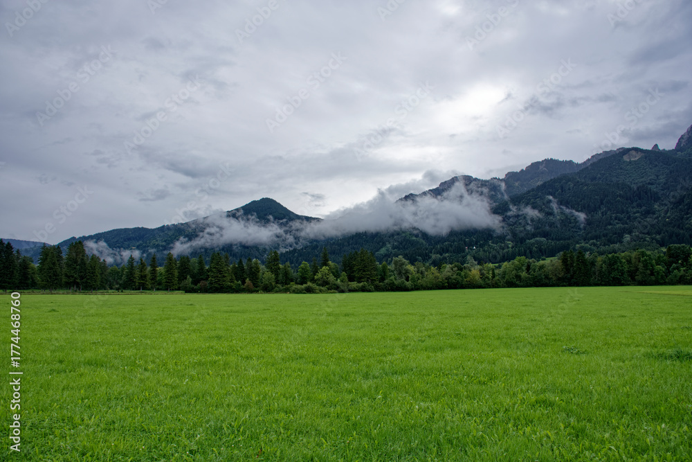 Fototapeta premium A cloudy autumn day near a castle at the foot of the Alps.