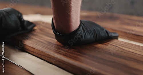 woodworker applying oil finish to black walnut board
