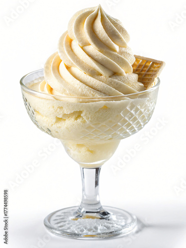 Delicious creamy vanilla soft serve ice cream in a clear glass cup with a wafer garnish	