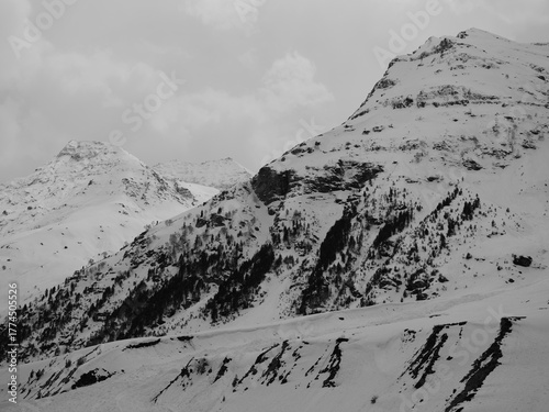 Black and white photo of mountain tops covered with snow