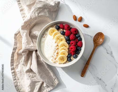 Healthy Oatmeal Breakfast Bowl with Fresh Berries, Banana Slices, and Almonds