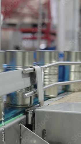 Tomato sauce cans on a conveyor belt in a canned food production facility