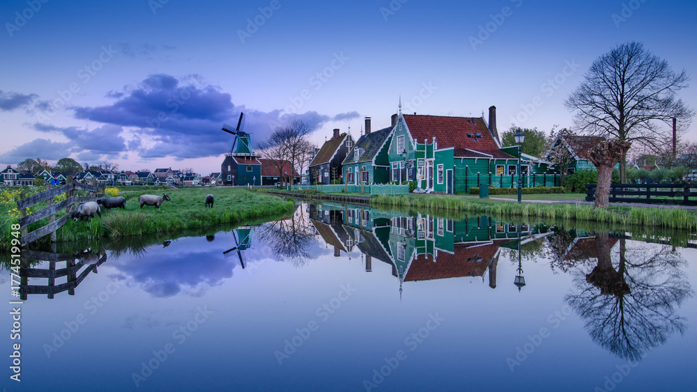Fototapeta premium De Zaanse Schans is a neighborhood located in the city of Zandam. Historical windmills and old houses were relocated here to create the vintage look. And the famous Dutch canals near Amsterdam