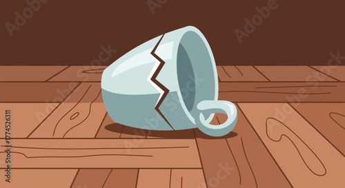Broken ceramic cup lying on a wooden floor.