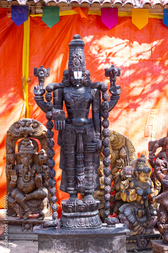 Wooden art, Handmade wooden idol on lord tirupati at surajkund craft fair. Selective focus.