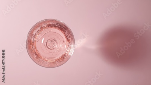 brut. Glass of rose sparkling wine on a pastel pink background, captured from above with soft shadows and studio lighting. bar promotions.