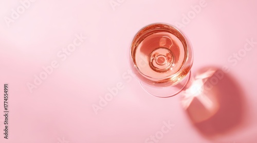 brut. Glass of rose sparkling wine on a pastel pink background, captured from above with soft shadows and studio lighting. bar promotions.