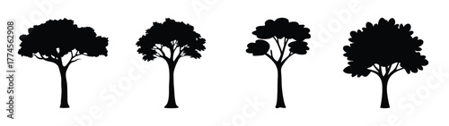 Four silhouetted trees representing nature green living sustainability growth and environment