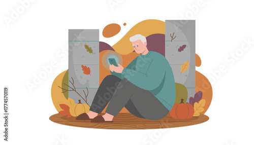 Elderly man sits sadly fixated on his smartphone screen in an isolated autumnal setting