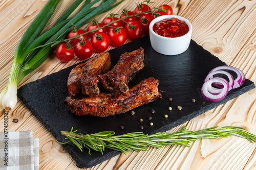Grilled ribs, shashlik on a wooden table