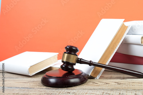 Law concept - Open law book with a wooden judges gavel on table in a courtroom or law enforcement office isolated on white background. Copy space for text.