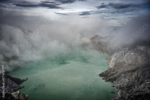 The acidic lake of Kawah Ijen in its fog