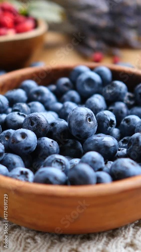Wallpaper Mural Freshly picked organic blueberries gently falling into a rustic wooden bowl. With sweet berries and lavender in the background. Creating a perfect scene for healthy eating and summer dessert concepts Torontodigital.ca