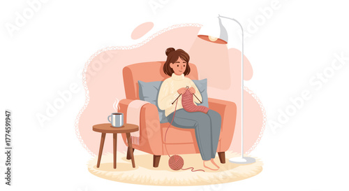 A young woman enjoys a peaceful moment at home, comfortably seated in an armchair while diligently knitting a warm garment.