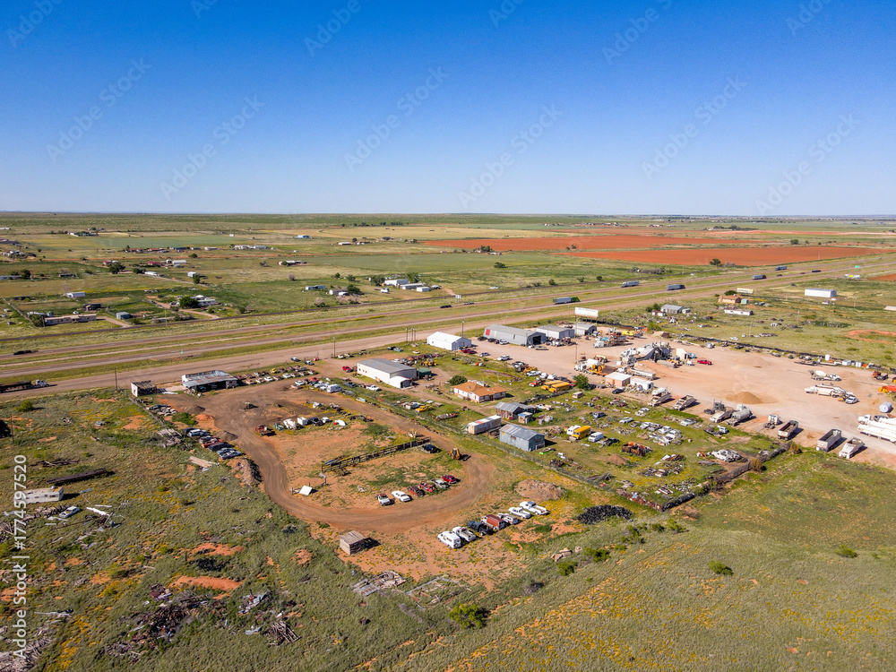 Obraz premium Aerial landscape of desert car graveyard in rural historic US route 66 Tucumcari New Mexico NM