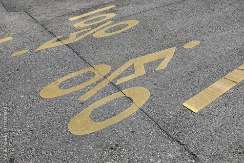 A yellow silhouette of a bicycle has been painted on a bike path in Geneva, Switzerland