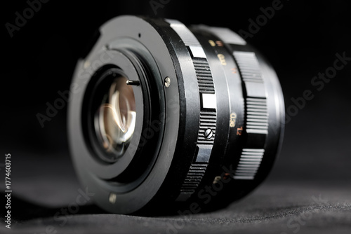 This lens has a focal length of 50 millimeters and is designed for use with an analog SLR camera