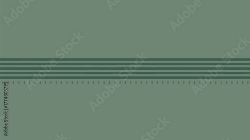 A close up of a green wall with horizontal lines and small vertical marks along the bottom edge