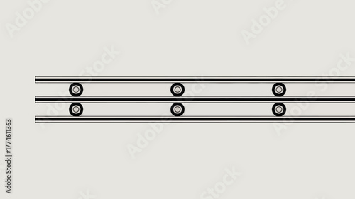 A top view of a linear rail system with bearings and metal tracks on a light gray background surface