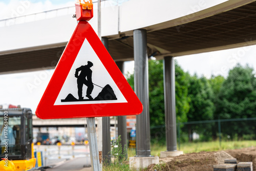Road Work Warning Sign Near Urban Bridge Construction