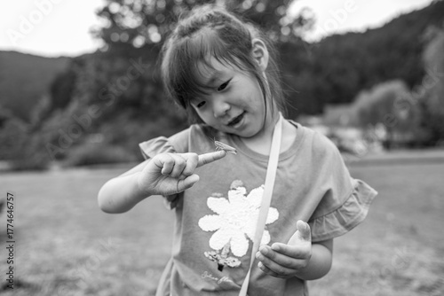 A little girl with a grasshopper on her finger