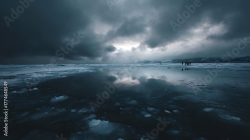 A dramatic frozen landscape under a dark cloudy sky with clear reflections on the ice and distant figures