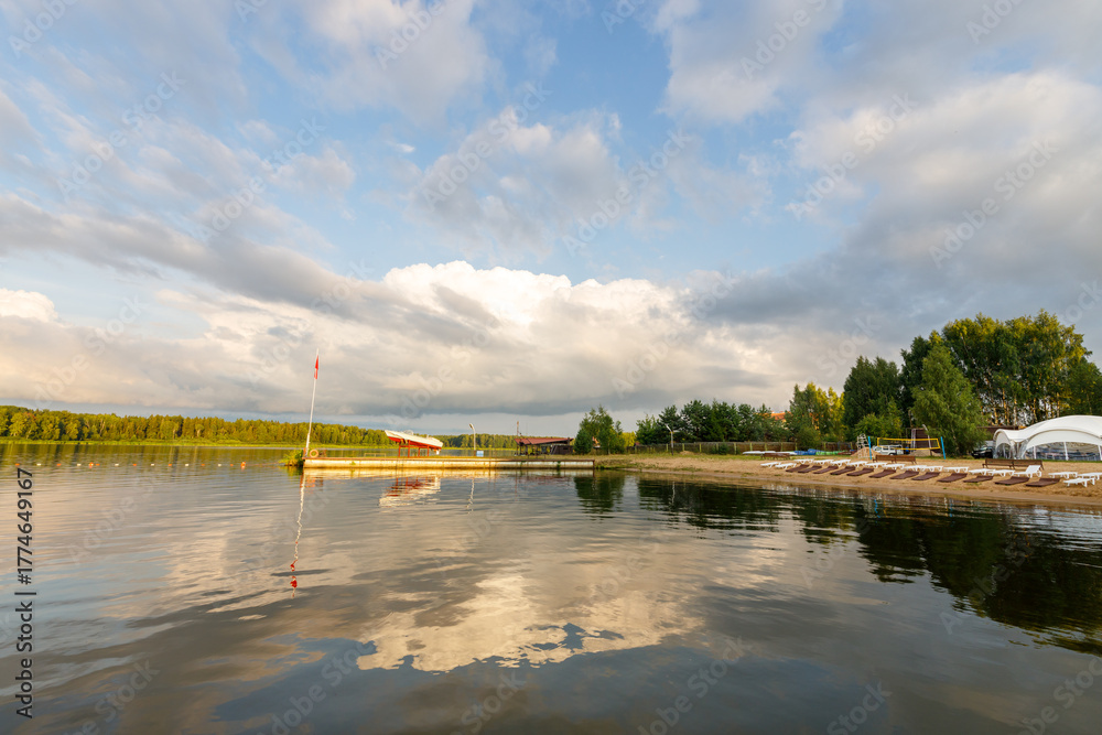 Fototapeta premium Calm lake with a dock and a few boats