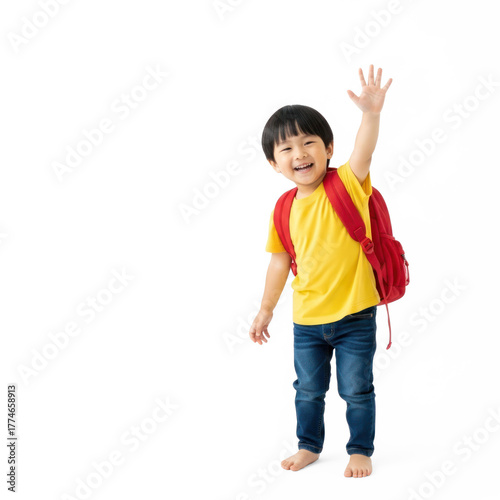 A young child wearing a yellow shirt and blue jeans, waving with a red backpack on a white background.