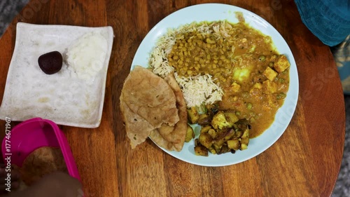 Traditional Indian vegetarian thali with dal rice paneer and roti