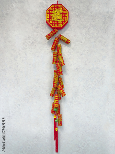 Decorative charms hanging vertically from a wall in an oriental Chinese restaurant.