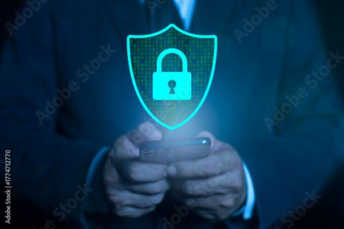 Phone data security protect from scam and mobile crime. Concept of digital security, internet protection and cyber crime. Businessman holding smartphone with a blue shield on it.